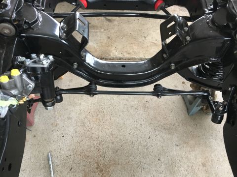 1967 Ford Galaxie - Close-up view of a vehicle's front suspension and frame assembly, showing steering linkage and springs.