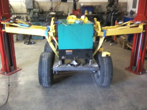 1984 Honda ATC 250 R - Generator unit on a trailer, secured with yellow straps, in a workshop setting.