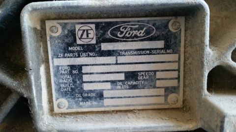 1985 Ford Bronco - Close-up of a ZF transmission identification tag, the Ford logo and various part and serial numbers.