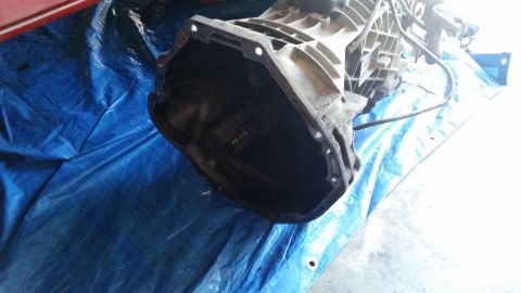 1985 Ford Bronco - Transmission part on blue tarp, likely from a vehicle.