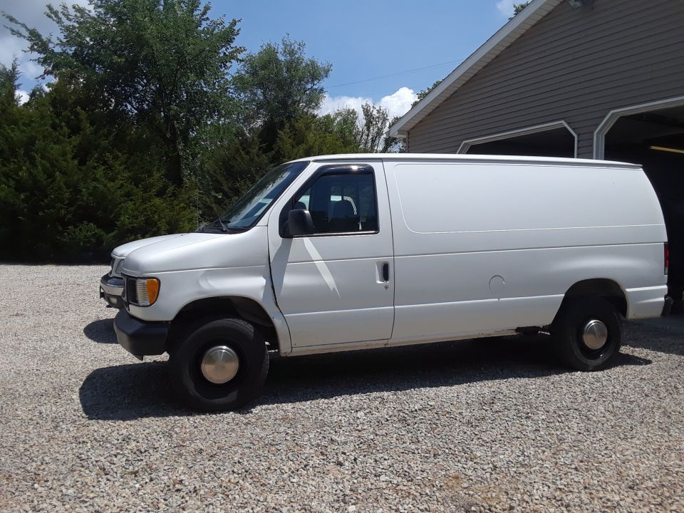 White 1999 Ford E250 cargo van, side view