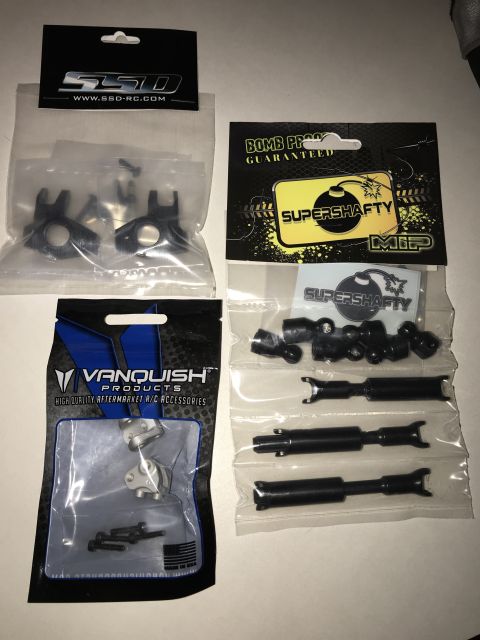1989 Ford Bronco - Various aftermarket parts for remote control vehicles are displayed in their original packaging.