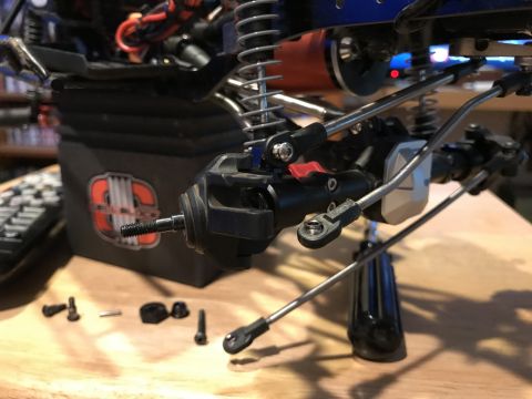 1989 Ford Bronco - Detailed view of unassembled suspension parts and hardware for a radio-controlled vehicle.