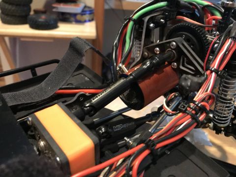 1989 Ford Bronco - Close-up view of a complex RC car chassis, showing mechanical components and wiring harnesses.