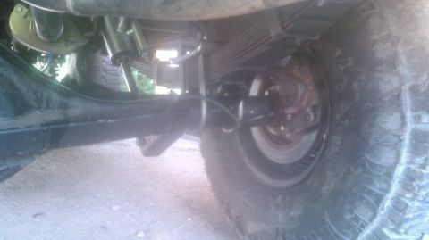 1978 Ford Bronco - The photo shows the rear suspension and axle assembly of a vehicle, including leaf springs and a shock absorber.