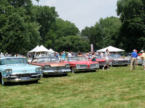 1971 Ford Ranchero - Several vintage automobiles are displayed on a grassy field under a cloudy sky.