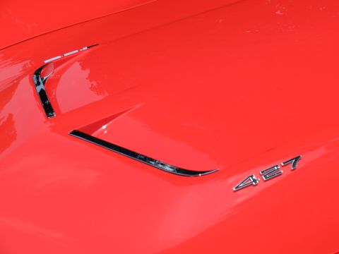 1971 Ford Ranchero - A close-up of a red car's hood reveals chrome accents and a '427' emblem, with visible watermarks.