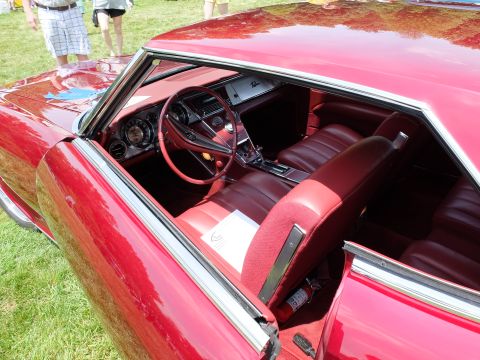 1971 Ford Ranchero - The interior of a red 1966 Buick Riviera shows off its plush seating and classic dashboard design.