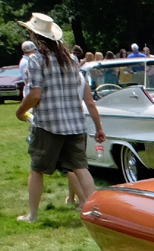White convertible with prominent chrome trim, seen from the side