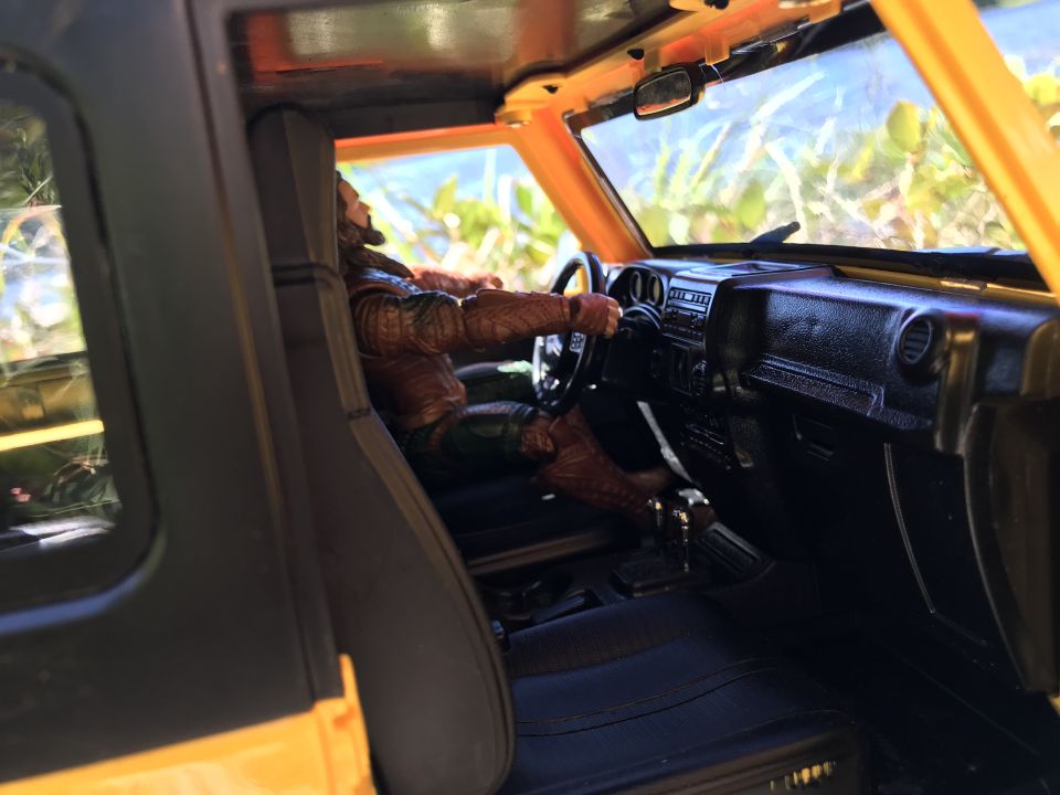 toy jeep interior with aquaman figure driving