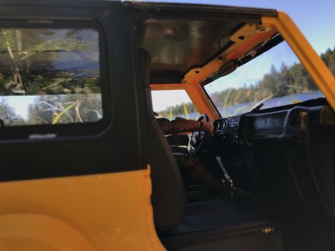 1989 Ford Bronco - Close-up view of a toy vehicle's interior, showing the dashboard and steering wheel.