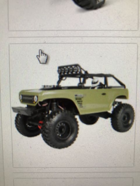 1989 Ford Bronco - This toy truck features an olive green body, a roof rack, and oversized off-road tires.