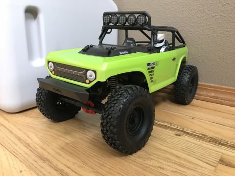 1989 Ford Bronco - This lime green RC car features aggressive off-road tires, a protective roll cage, and a light bar on the roof.