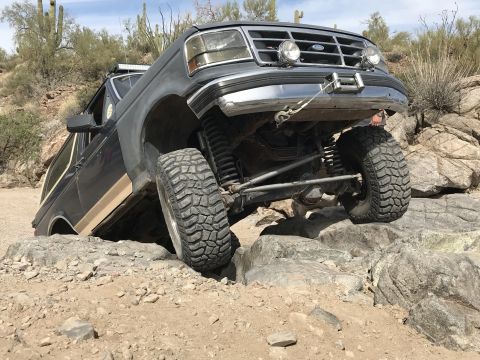 1991 Ford Bronco - This 1991 Ford Bronco is shown off-roading on a rocky trail.