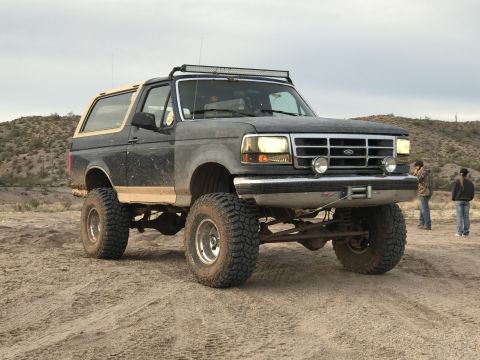 1991 Ford Bronco - This lifted Ford Bronco features off-road tires and a light bar, suggesting it is from the 1992-1996 generation.