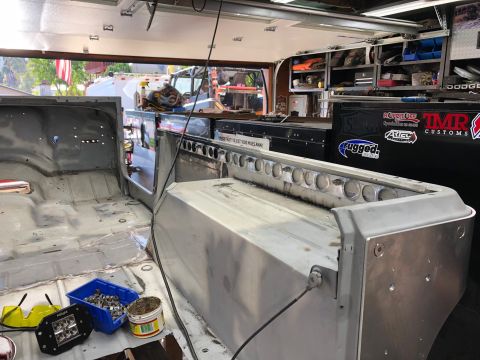1992 Jeep Wrangler - Interior of a Jeep being worked on, with tools and parts visible in a garage setting.