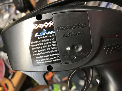 1989 Ford Bronco - Close-up of a black Traxxas remote control transmitter with "Link Enabled" sticker and "Traxxas Link" logo.