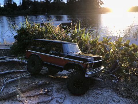 1989 Ford Bronco - RC toy Bronco with wood paneling sits by a lake during golden hour.
