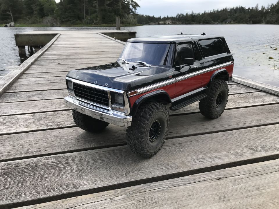 Black and red Ford Bronco model on wooden dock