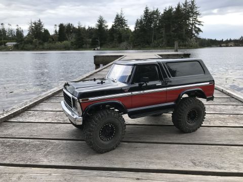 1989 Ford Bronco - This SUV, resembling a 1978 Ford Bronco, sits on a wooden dock next to a lake.