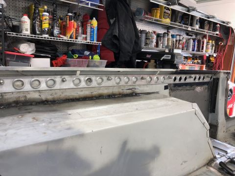 1992 Jeep Wrangler - The interior of a vehicle is shown with shelves of automotive supplies in the background.