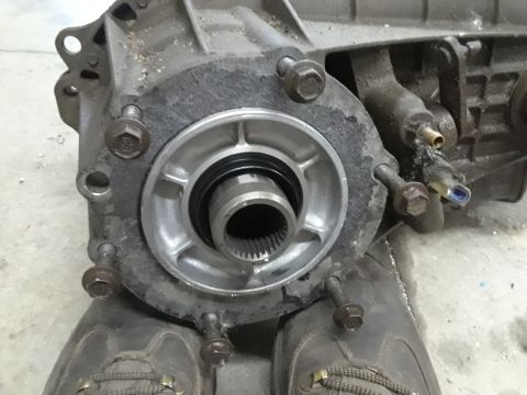 1996 Ford F-350 - Close-up view of a transfer case component, showing the splined output shaft and mounting bolts.
