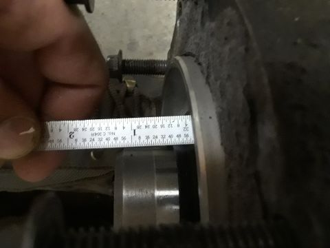 1996 Ford F-350 - A ruler is used to measure a metal part, possibly for an automotive repair or build.