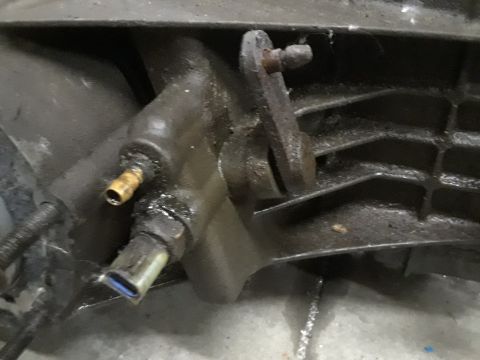 1996 Ford F-350 - This is a close-up view of a vehicle's transfer case, showing various mechanical components and signs of grease.