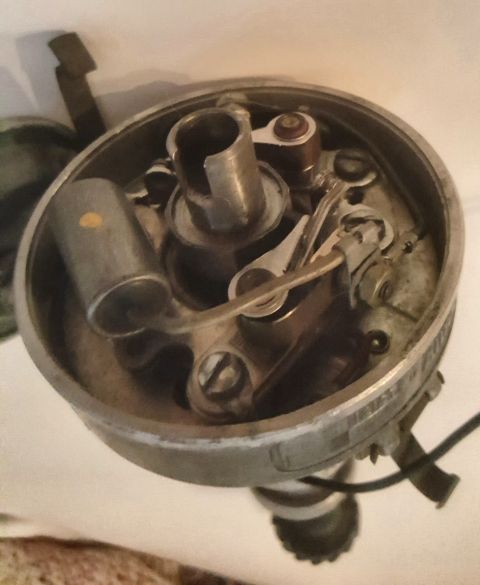 1973 Ford Mustang - Interior view of a car's distributor cap, revealing the ignition points and rotor mechanism.