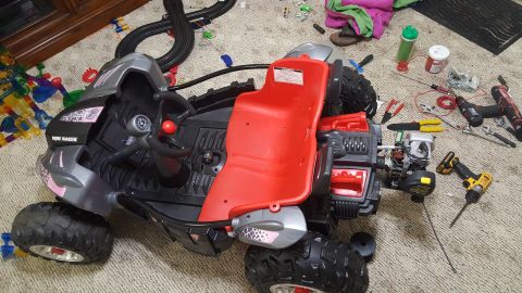 2007 Subaru Impreza - A disassembled toy dune buggy sits on a carpeted floor surrounded by tools and toy tracks.