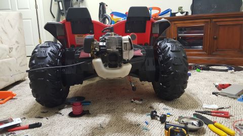 2007 Subaru Impreza - This ride-on toy vehicle has large knobby tires and an exposed engine, not a 2007 Subaru Impreza.