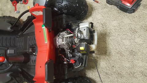 2007 Subaru Impreza - The engine and part of the frame of a toy ATV are shown on a carpeted floor.