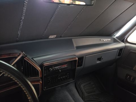 1989 Ford Bronco - Interior view of a 1989 Ford Bronco XLT dashboard, showing the radio and wood trim accents.