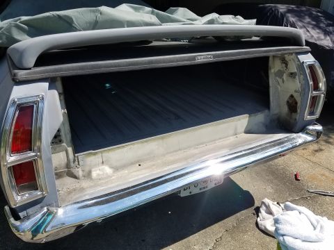 1976 Ford Ranchero - Rear view of a gray 1972 Ford Ranchero pickup truck bed, showing the chrome bumper and taillights.