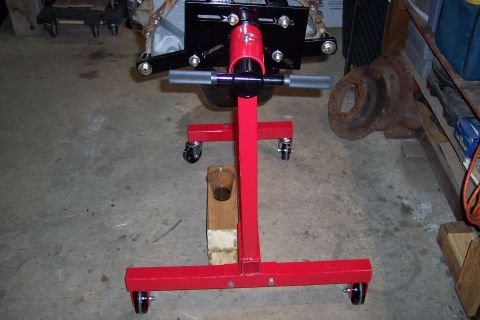 1995 Ford Bronco - Engine on a stand in a garage setting, with various parts visible in the background.