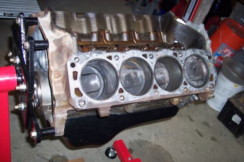 1995 Ford Bronco - Engine block on a stand, showing the cylinder bores and gasket surface.