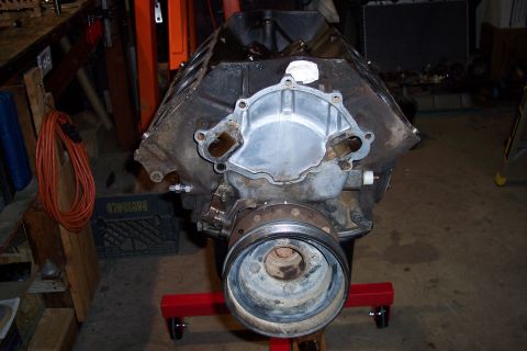 1995 Ford Bronco - Engine block on a stand, showing the front of the engine with the water pump housing attached.
