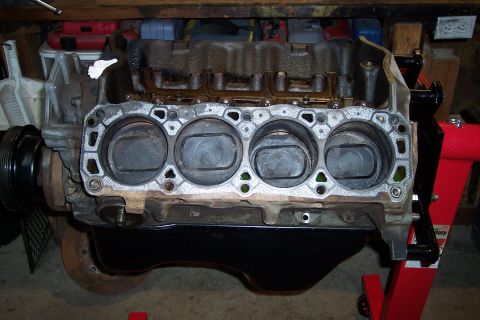 1995 Ford Bronco - Engine block with pistons exposed, likely undergoing repair or rebuild.