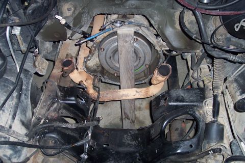1995 Ford Bronco - The transmission and exhaust system of a vehicle are visible in this close-up shot.
