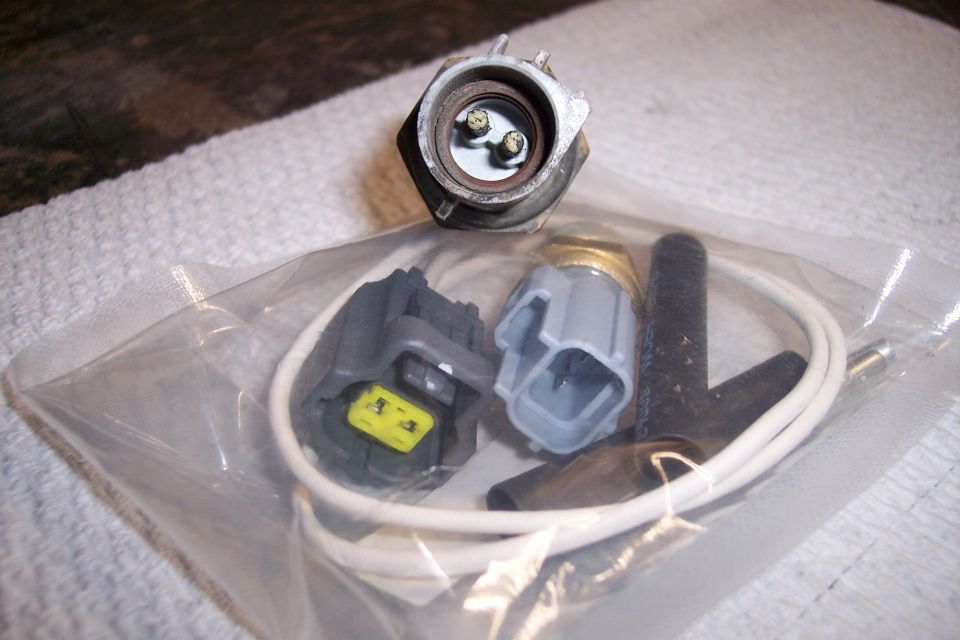 engine coolant temp sensor with two plastic electrical connectors and a white wire
