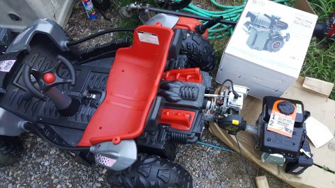 2007 Subaru Impreza - A toy dune buggy with its steering wheel and red seat visible, alongside a detached gas engine.