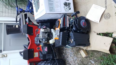 2007 Subaru Impreza - Two engines are mounted on a red ATV frame next to a cardboard box and some documents.