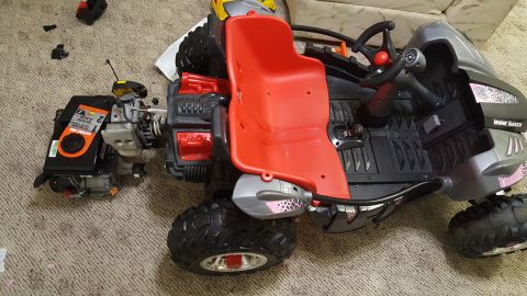 2007 Subaru Impreza - A toy dune buggy with a detached engine sits on a carpeted floor.