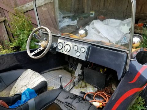 1968 Ford Mustang - The interior of a custom hot rod features a wood-rimmed steering wheel, a dashboard with multiple gauges, and black seats, suggesting a non…