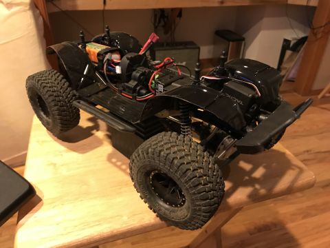 1989 Ford Bronco - This remote-controlled rock crawler features a detailed chassis with visible wiring and a battery pack.