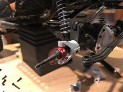 1989 Ford Bronco - RC car suspension part with visible branding on the red component.