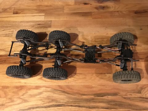 1989 Ford Bronco - This RC car chassis features a six-wheel drive system and detailed suspension components.