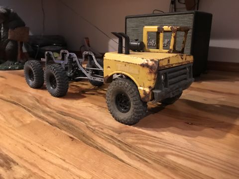 1989 Ford Bronco - This custom 6x6 truck chassis features a weathered yellow cab and exposed suspension components.
