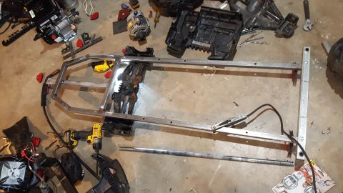 2007 Subaru Impreza - Work in progress: aluminum frame, engine parts, and tools laid out on a garage floor.