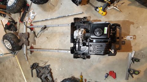 2007 Subaru Impreza - A go-kart frame is assembled with an engine and wheels, with tools nearby.